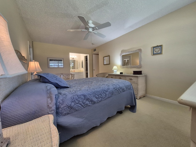 bedroom featuring ceiling fan, a textured ceiling, baseboards, ensuite bathroom, and light carpet