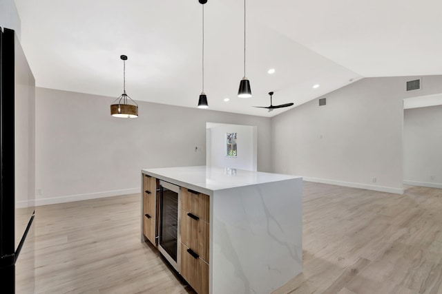 2410 SW 1st St, Boynton Beach, FL 33435 - kitchen featuring beverage cooler, a center island, visible vents, modern cabinets, and lofted ceiling