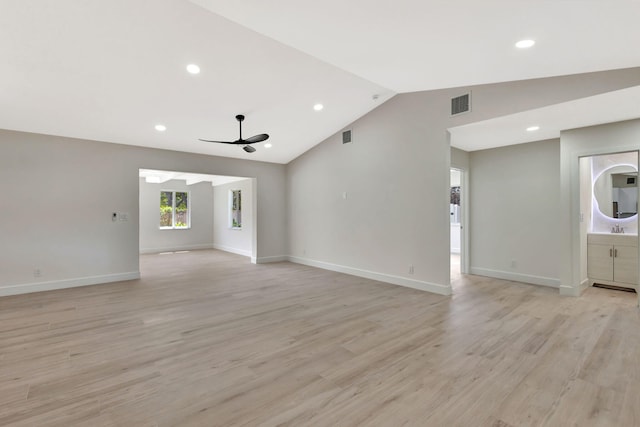2410 SW 1st St, Boynton Beach, FL 33435 - unfurnished living room featuring lofted ceiling, baseboards, light wood-type flooring, and visible vents