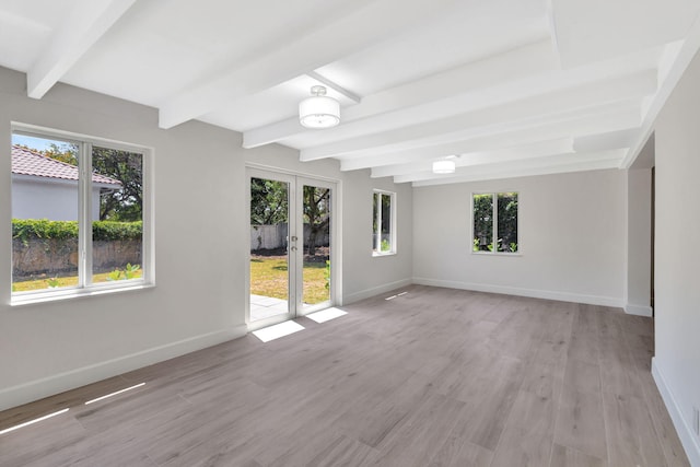 2410 SW 1st St, Boynton Beach, FL 33435 - empty room featuring baseboards, beamed ceiling, french doors, and light wood-style flooring