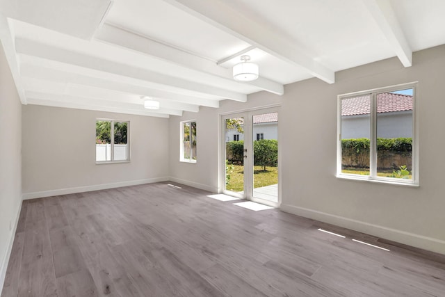 2410 SW 1st St, Boynton Beach, FL 33435 - empty room featuring baseboards, beam ceiling, and wood finished floors