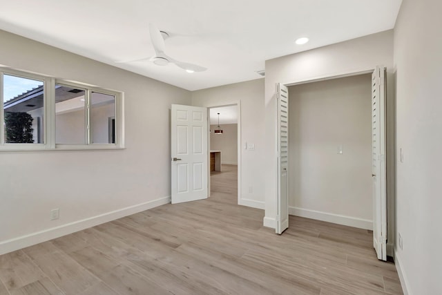 2410 SW 1st St, Boynton Beach, FL 33435 - unfurnished bedroom with light wood finished floors, baseboards, a ceiling fan, and recessed lighting