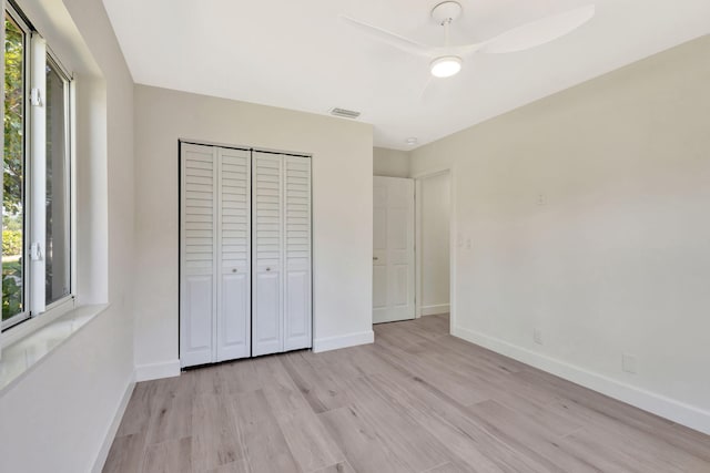 2410 SW 1st St, Boynton Beach, FL 33435 - unfurnished bedroom featuring a ceiling fan, baseboards, light wood-type flooring, and a closet