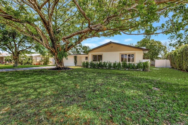 2410 SW 1st St, Boynton Beach, FL 33435 - ranch-style house featuring a front lawn, a garage, fence, and concrete driveway