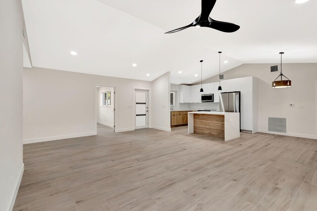 2410 SW 1st St, Boynton Beach, FL 33435 - kitchen with stainless steel appliances, lofted ceiling, visible vents, and open floor plan