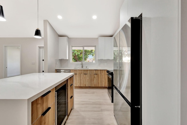 2410 SW 1st St, Boynton Beach, FL 33435 - kitchen featuring stainless steel fridge, a sink, pendant lighting, modern cabinets, and wine cooler
