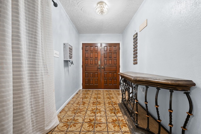 115 NE Caprona Ave, Port Saint Lucie, FL 34983 - entrance foyer featuring baseboards and a textured ceiling