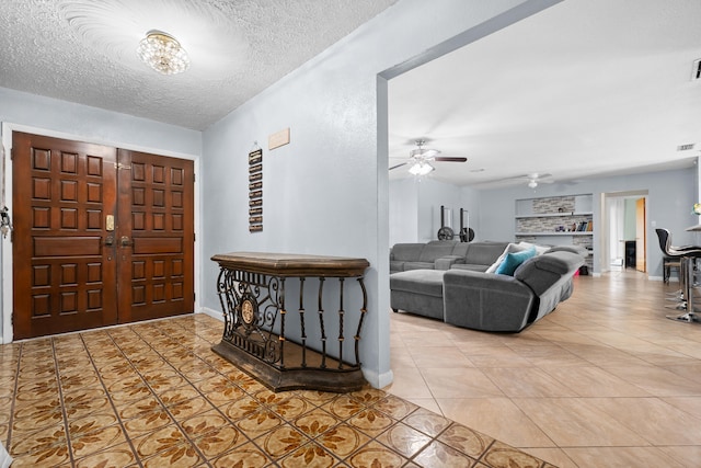 115 NE Caprona Ave, Port Saint Lucie, FL 34983 - tiled entrance foyer with a ceiling fan, visible vents, and a textured ceiling