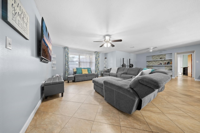 115 NE Caprona Ave, Port Saint Lucie, FL 34983 - living room featuring a ceiling fan, baseboards, and light tile patterned floors