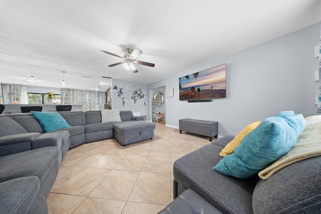 115 NE Caprona Ave, Port Saint Lucie, FL 34983 - living room with wallpapered walls, light tile patterned floors, baseboards, and ceiling fan