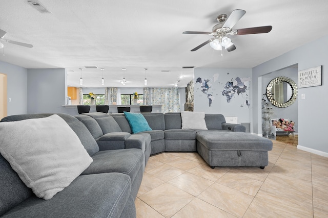 115 NE Caprona Ave, Port Saint Lucie, FL 34983 - living area with light tile patterned floors, baseboards, visible vents, and ceiling fan