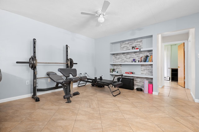 115 NE Caprona Ave, Port Saint Lucie, FL 34983 - workout area featuring light tile patterned floors, a ceiling fan, a textured ceiling, built in features, and baseboards