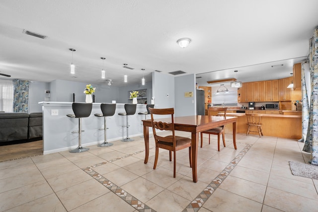 115 NE Caprona Ave, Port Saint Lucie, FL 34983 - dining room with light tile patterned flooring, baseboards, and visible vents