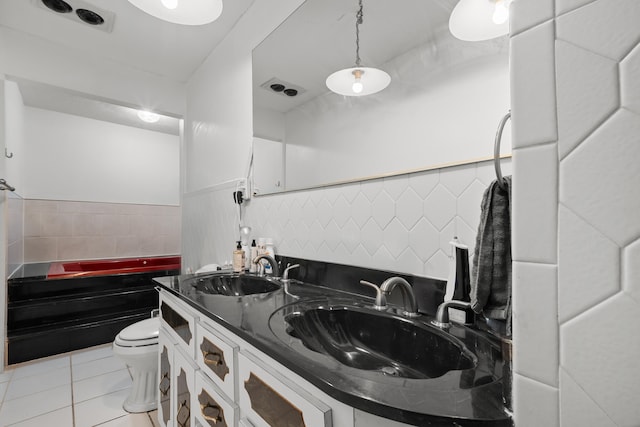 115 NE Caprona Ave, Port Saint Lucie, FL 34983 - full bathroom featuring toilet, a bath, tile patterned flooring, and a sink