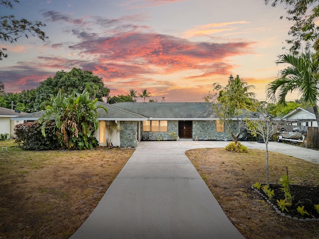 115 NE Caprona Ave, Port Saint Lucie, FL 34983 - single story home featuring concrete driveway and stone siding