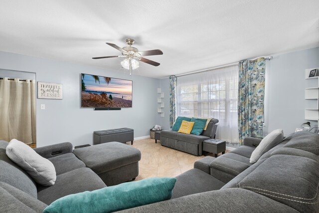 115 NE Caprona Ave, Port Saint Lucie, FL 34983 - living area with baseboards, ceiling fan, and light tile patterned flooring