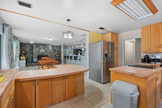115 NE Caprona Ave, Port Saint Lucie, FL 34983 - kitchen featuring hanging light fixtures, light tile patterned floors, stainless steel appliances, and visible vents