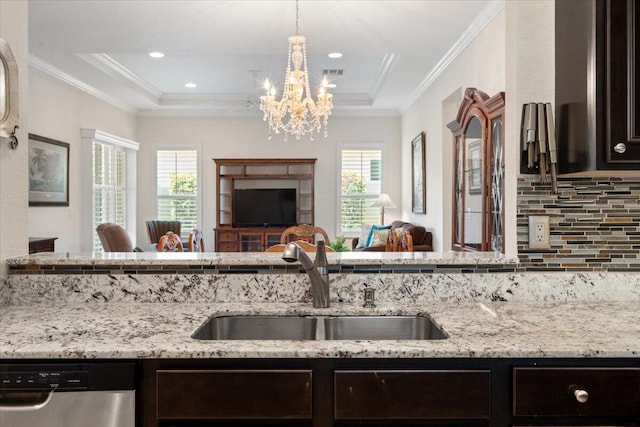 10145 SW Canossa Way, Port Saint Lucie, FL 34986 - kitchen with stainless steel dishwasher, open floor plan, a chandelier, a sink, and backsplash