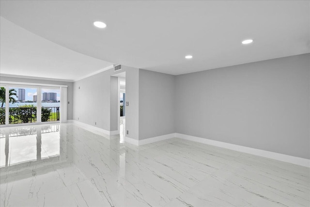 3040 Lake Shore Dr Unit 101, Riviera Beach, FL 33404 - unfurnished room with light marble finish floors, baseboards, and recessed lighting