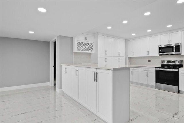 3040 Lake Shore Dr Unit 101, Riviera Beach, FL 33404 - kitchen featuring stainless steel appliances, light marble finish flooring, recessed lighting, baseboards, and light countertops
