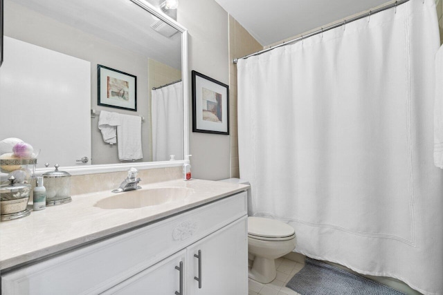 bathroom featuring vanity, tile patterned floors, and toilet