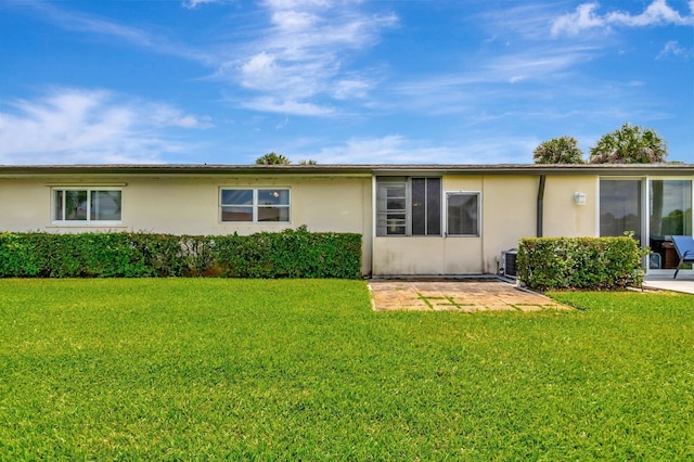 2867 Ashley Dr W Unit G, West Palm Beach, FL 33415 - rear view of property with a yard, a patio, cooling unit, and stucco siding