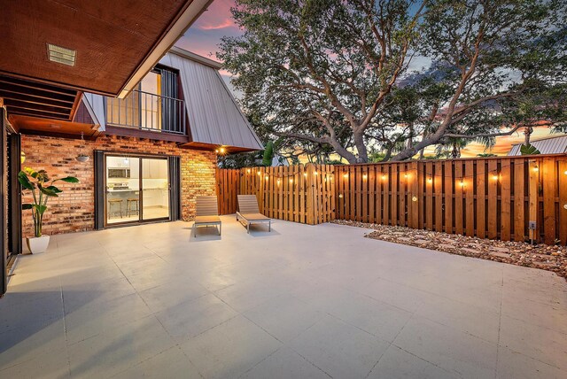 1420 Ocean Way Unit 30C, Jupiter, FL 33477 - patio terrace at dusk featuring a fenced backyard
