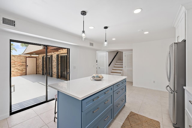 1420 Ocean Way Unit 30C, Jupiter, FL 33477 - kitchen featuring freestanding refrigerator, light countertops, white cabinetry, decorative light fixtures, and recessed lighting