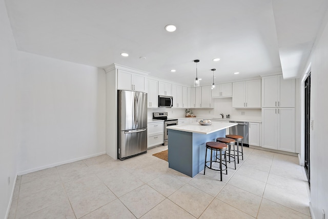 1420 Ocean Way Unit 30C, Jupiter, FL 33477 - kitchen featuring stainless steel appliances, recessed lighting, white cabinetry, a center island, and a breakfast bar area