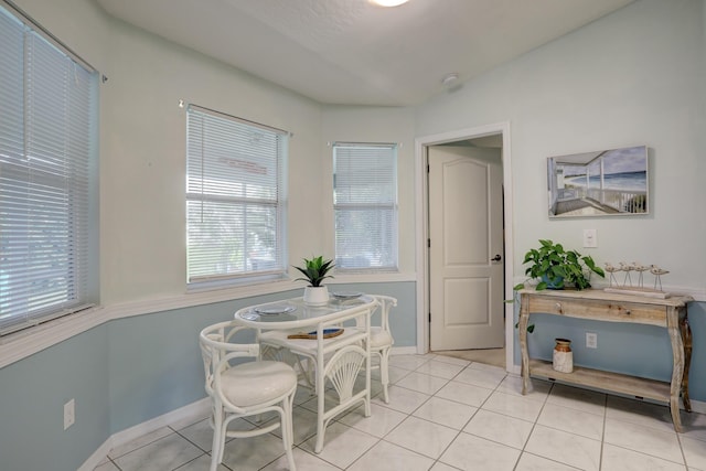 dining space with baseboards and light tile patterned flooring