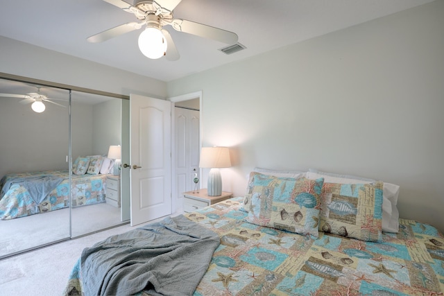 bedroom with visible vents, carpet flooring, ceiling fan, and a closet