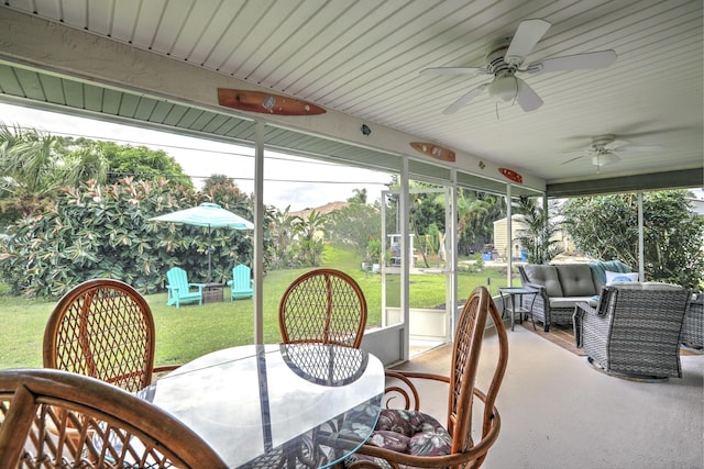 sunroom with an outdoor living space, a ceiling fan, and outdoor dining area