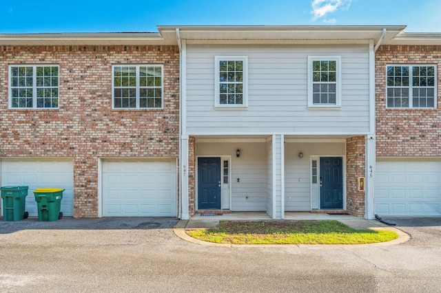 647 Gap Creek Dr, Fort Walton Beach, FL 32548 - townhome / multi-family property with a garage, brick siding, and driveway