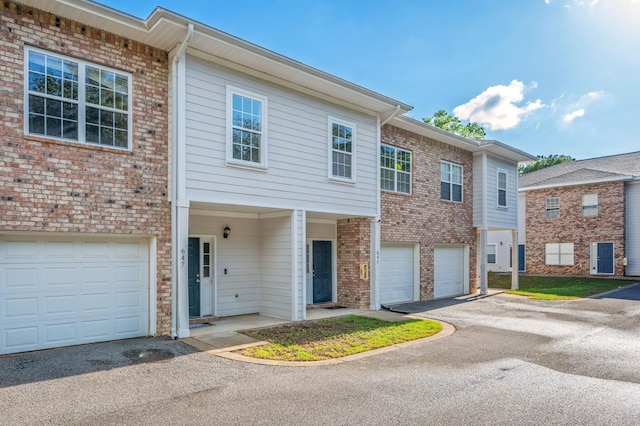 647 Gap Creek Dr, Fort Walton Beach, FL 32548 - townhome / multi-family property featuring a garage, driveway, and brick siding