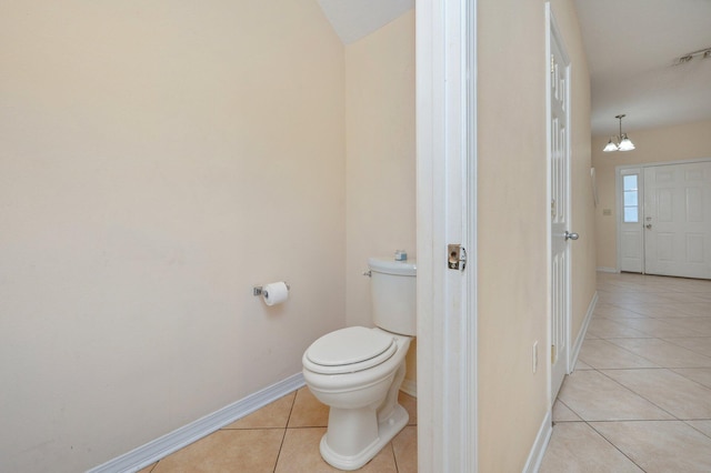647 Gap Creek Dr, Fort Walton Beach, FL 32548 - bathroom with tile patterned floors, toilet, baseboards, and a chandelier