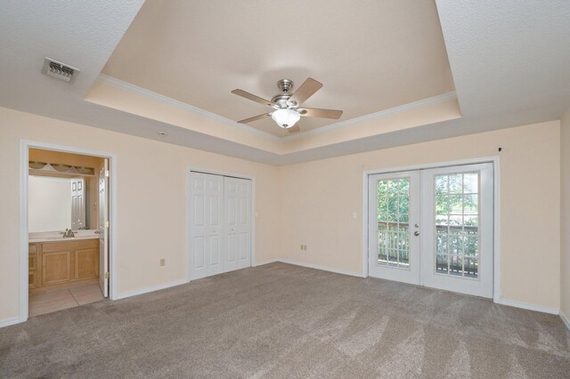 647 Gap Creek Dr, Fort Walton Beach, FL 32548 - unfurnished bedroom with a tray ceiling, light carpet, french doors, ornamental molding, and access to outside