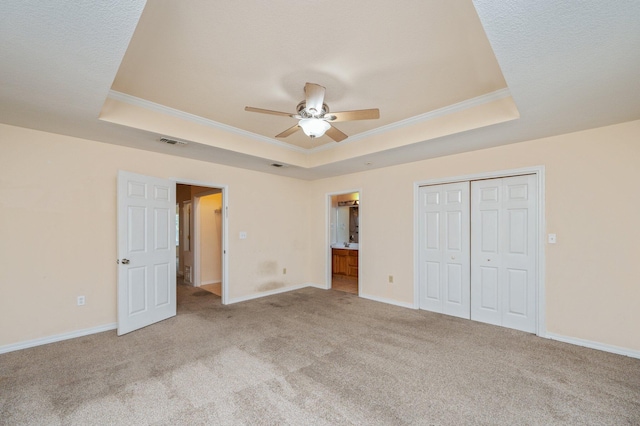 647 Gap Creek Dr, Fort Walton Beach, FL 32548 - unfurnished bedroom featuring a raised ceiling, crown molding, carpet flooring, a closet, and baseboards