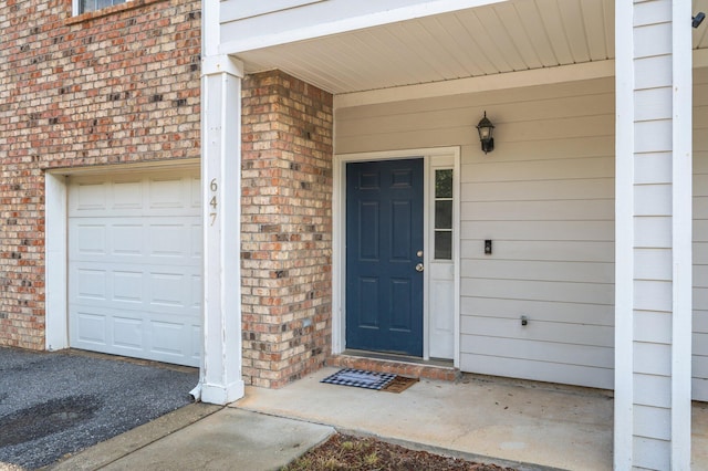 647 Gap Creek Dr, Fort Walton Beach, FL 32548 - view of exterior entry with brick siding and a garage