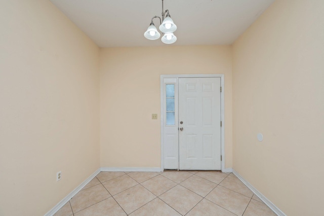 647 Gap Creek Dr, Fort Walton Beach, FL 32548 - empty room featuring a chandelier, light tile patterned floors, and baseboards