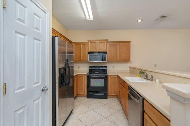 647 Gap Creek Dr, Fort Walton Beach, FL 32548 - kitchen with appliances with stainless steel finishes, a sink, light countertops, light tile patterned floors, and recessed lighting