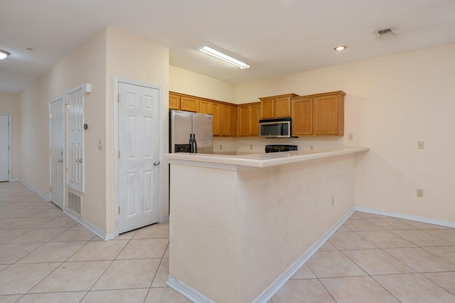 647 Gap Creek Dr, Fort Walton Beach, FL 32548 - kitchen featuring appliances with stainless steel finishes, light tile patterned floors, light countertops, a peninsula, and recessed lighting