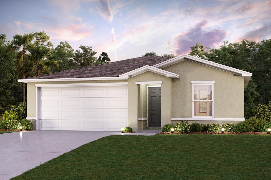 single story home featuring concrete driveway, a yard, stucco siding, and a garage