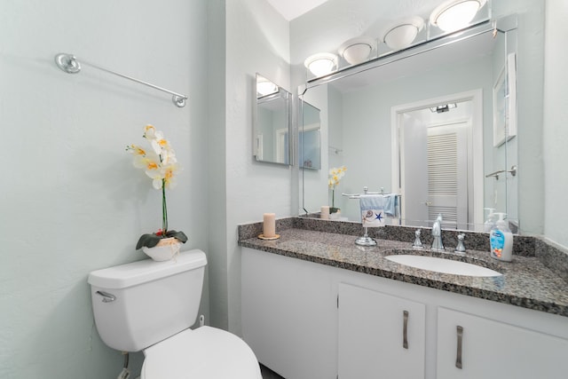 bathroom featuring toilet and vanity