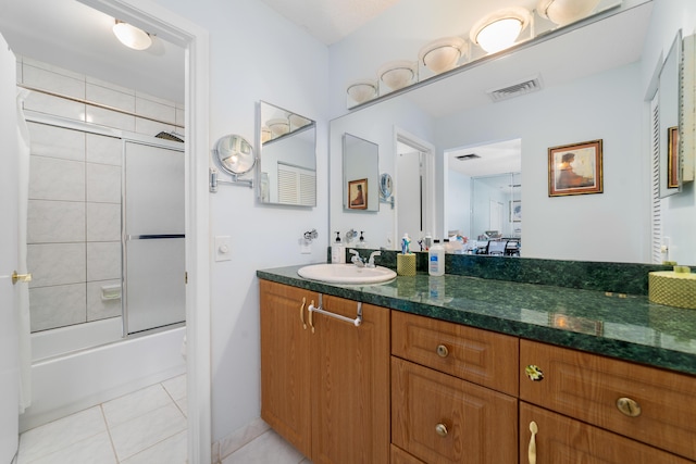 full bathroom with tile patterned floors, vanity, and enclosed tub / shower combo