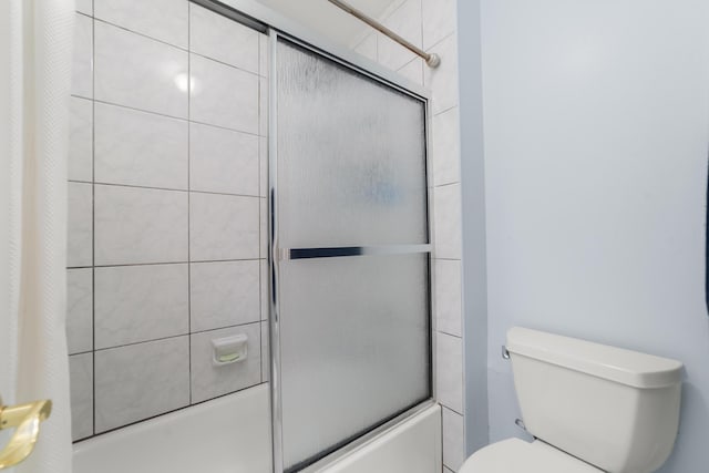 full bath featuring bath / shower combo with glass door and toilet