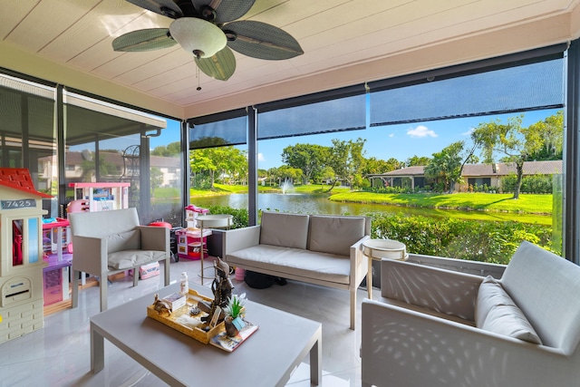 sunroom featuring an outdoor hangout area, a water view, and a ceiling fan