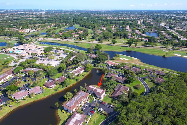aerial overview of property's location featuring a nearby body of water, nearby suburban area, and a golf club