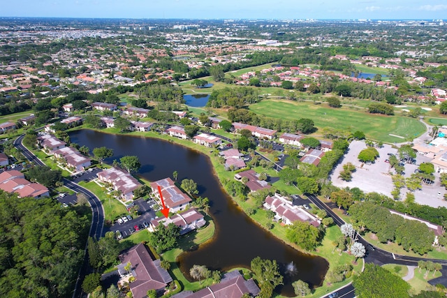 aerial view of property and surrounding area featuring a large body of water