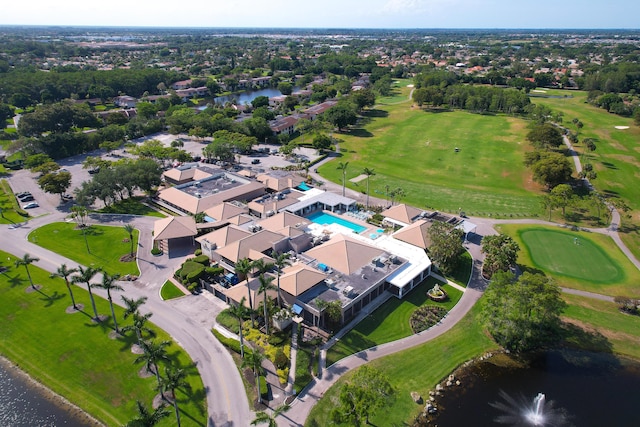 aerial view of property and surrounding area with a large body of water, a golf course, and a pool