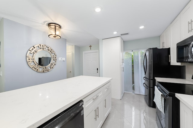 kitchen with black appliances, white cabinets, and recessed lighting